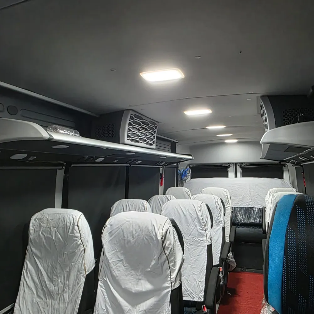 Interior aisle of a 17 seater Force Urbania showing standing headroom