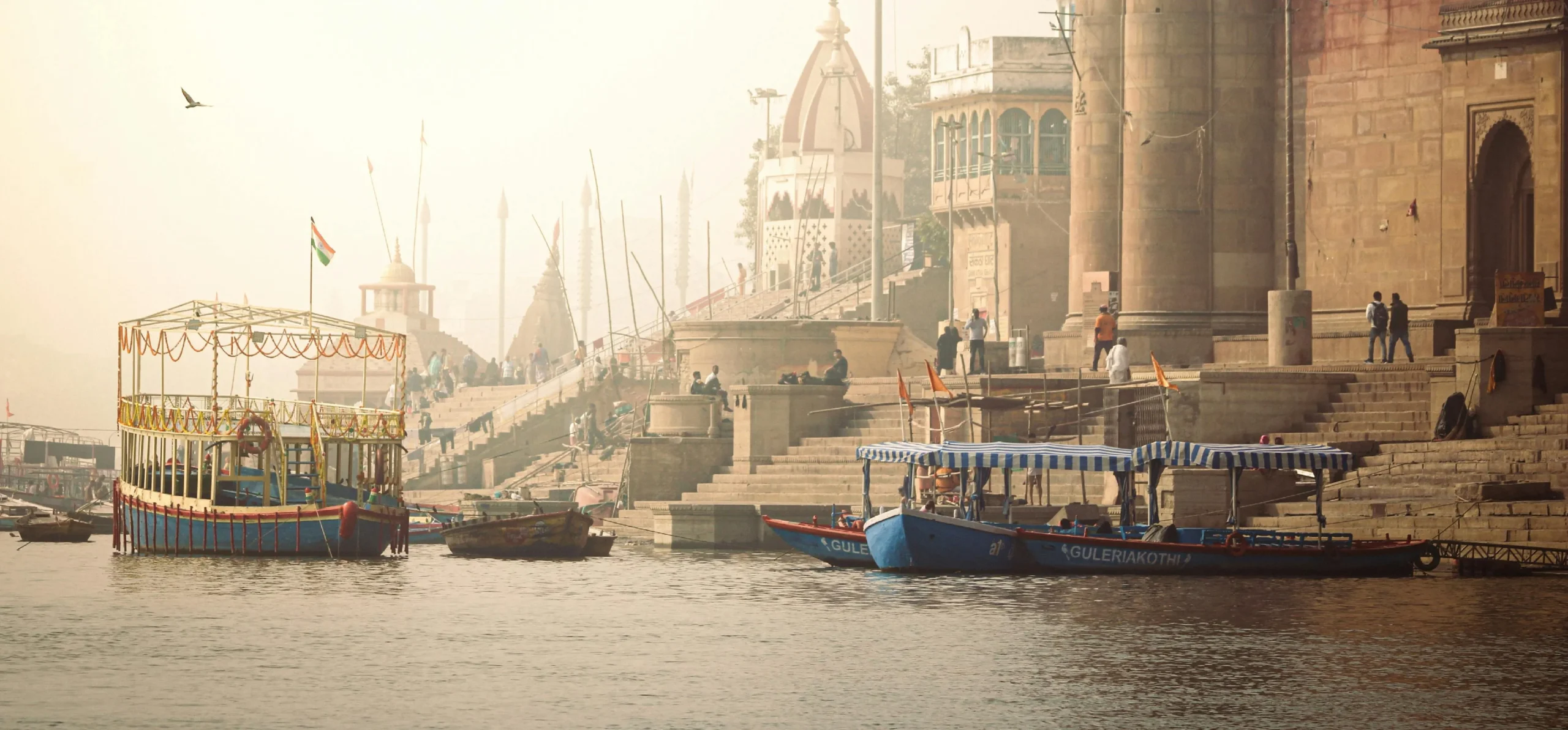 scenic view of Assi Ghat with ferry boats on the river