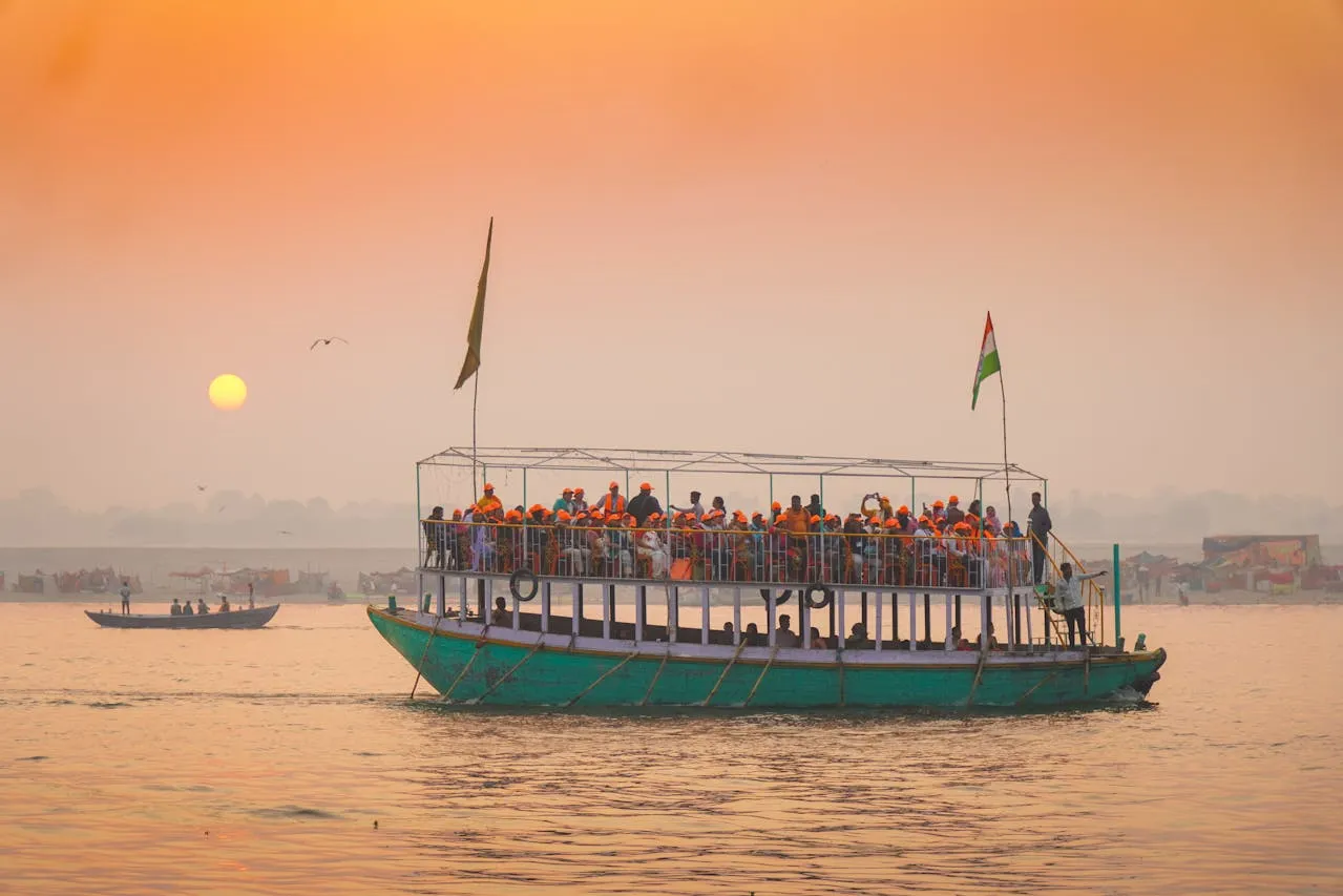 Traditional boatmen on the Ganges river at sunset
